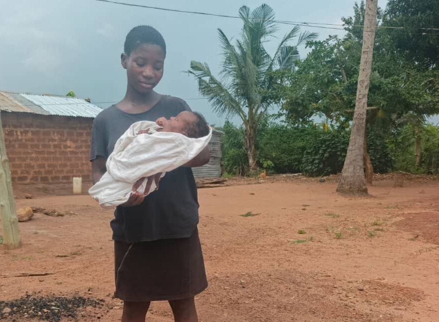 Girl holding a baby